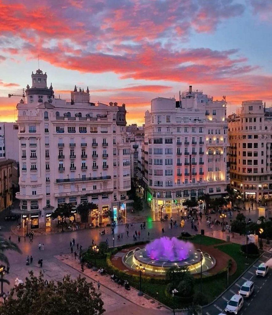 Place de l’Hôtel de Ville à Valence au coucher de soleil avec fontaine illuminée et bâtiments historiques
